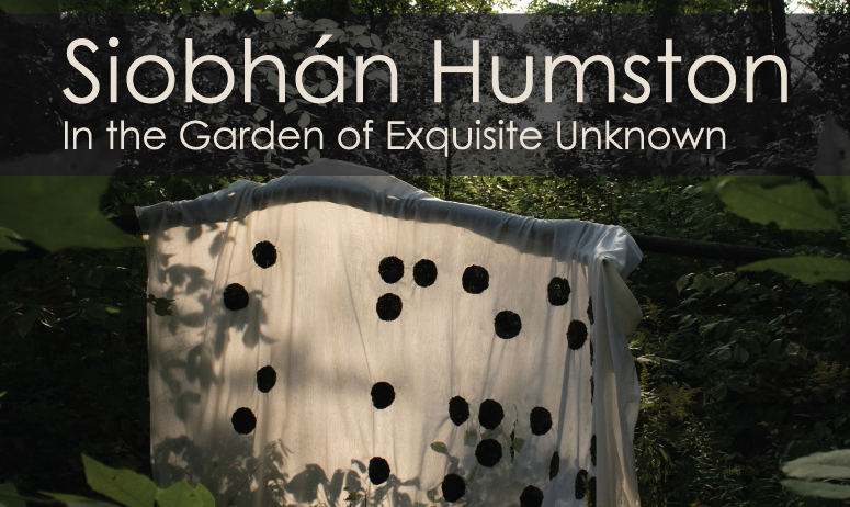 One of Siobhan's installations hanging in a lush area of foliage with the exhibition title "Siobhan Humston In the Garden of the Exquisite Unknown" over layed on top