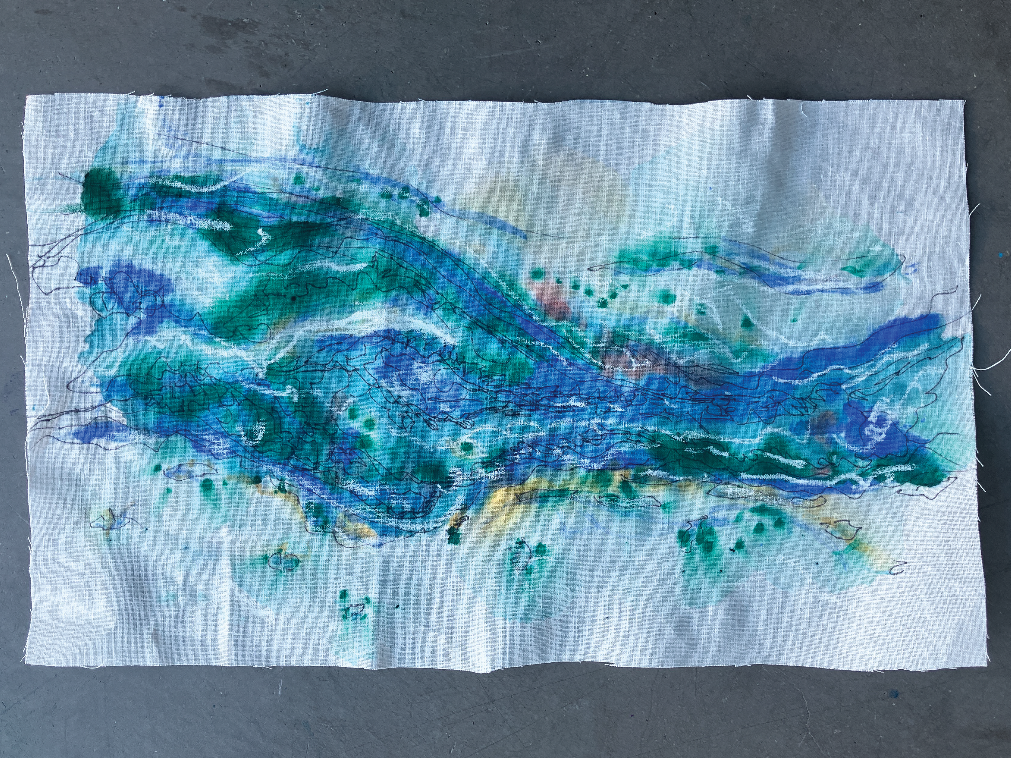 a white paper with an abstract watercolour painting with blues and greens