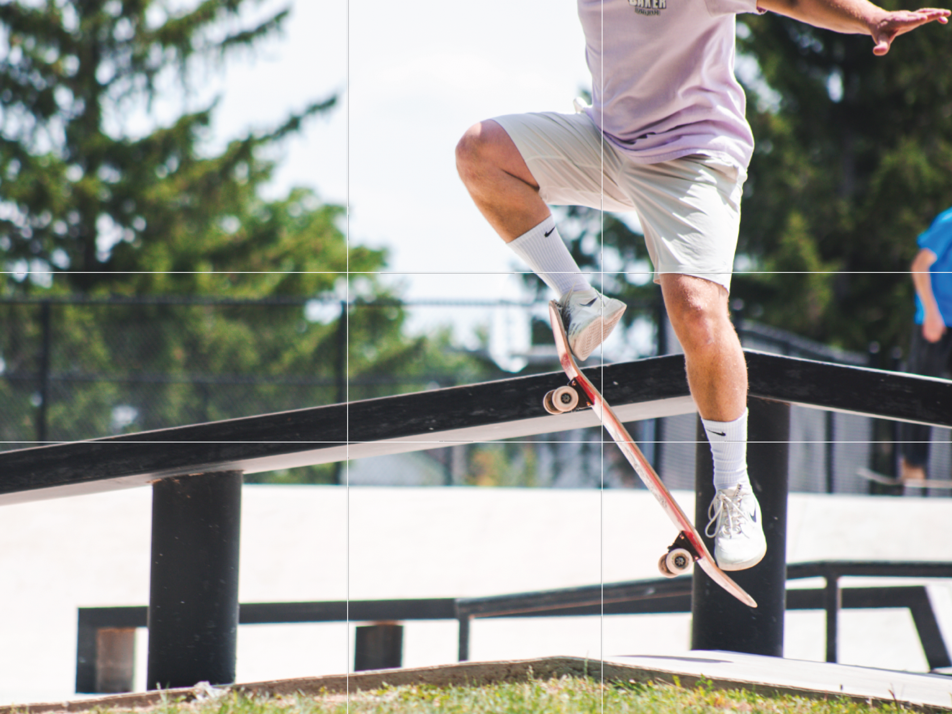 A photo of a skateboarder doing a kickflip is perfectly positioned in a grid to highlight the Rule of Thirds