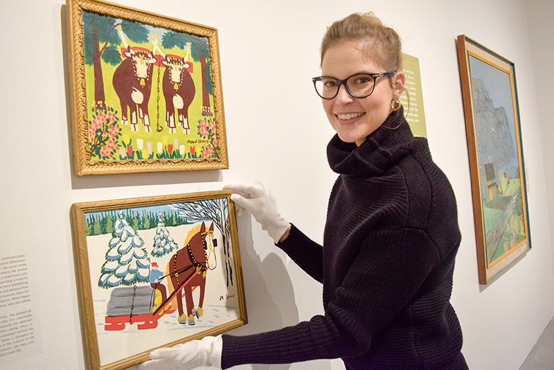 Curator, Sonya Blazek with Maud Lewis paintings