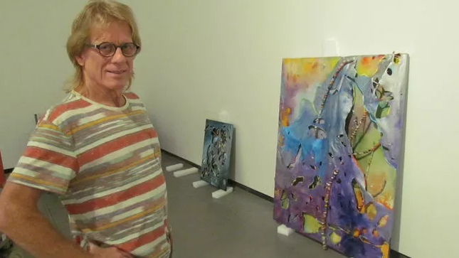 Artist Gary Nixon with his work